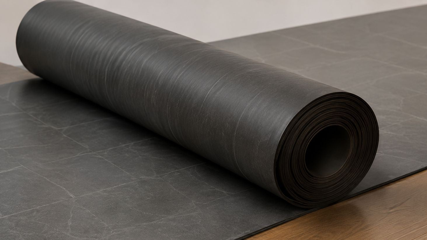 Roll of black leatherette on a gray surface